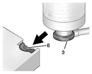 5. Slide the base of the tire sealant canister (3) into the slot on the top of