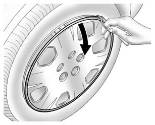 2. Remove the wheel cover, if the vehicle has one, to reach the wheel bolts.
